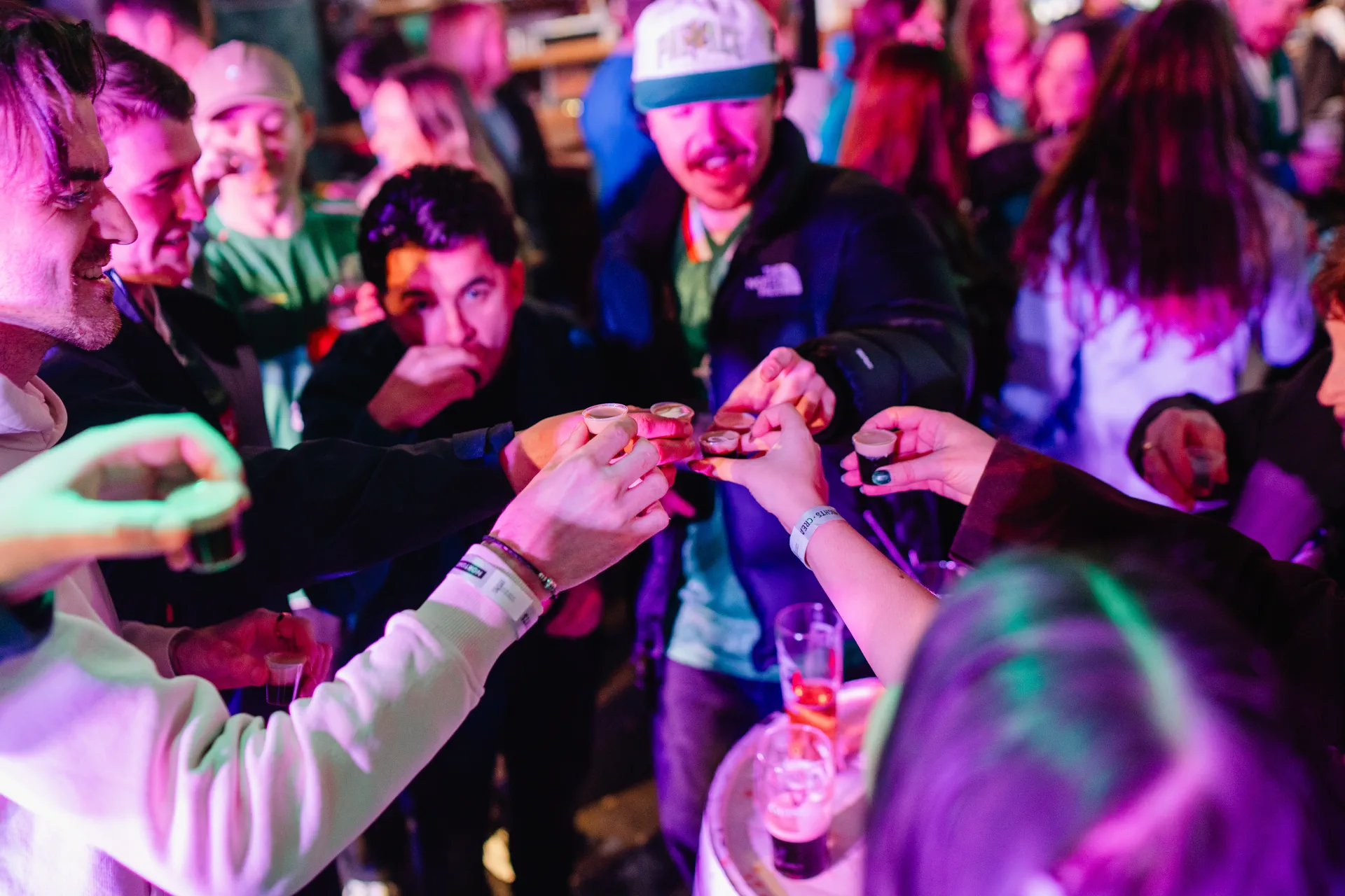 Friends clinking Baby Guinness shots on the dancefloor at Nortons Digbeth