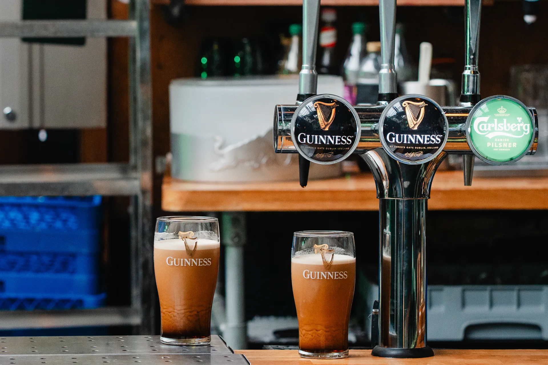 Two freshly poured creamy pints of Guinness settling on the bar at Nortons Digbeth